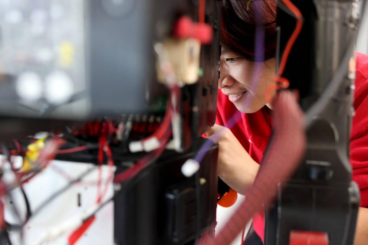 UNLV undergraduate research student Son Tran works on a robot in his lab in Las Vegas on Monday ...