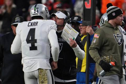 Las Vegas Raiders quarterback Derek Carr (4) and Las Vegas Raiders head coach Josh McDaniel tal ...