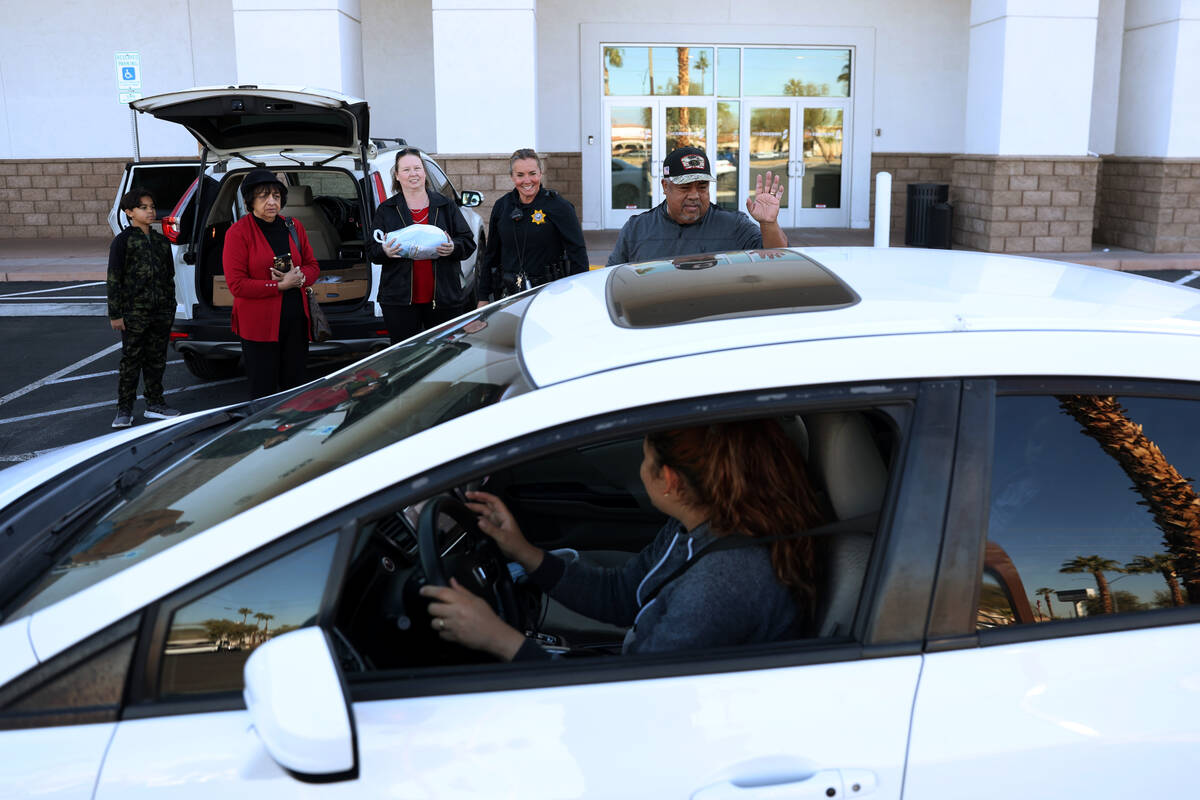 Derrian Rucker, from left, with Rita Vaswani, Faith Ramos, police officer Deborah Rinkovsky, an ...