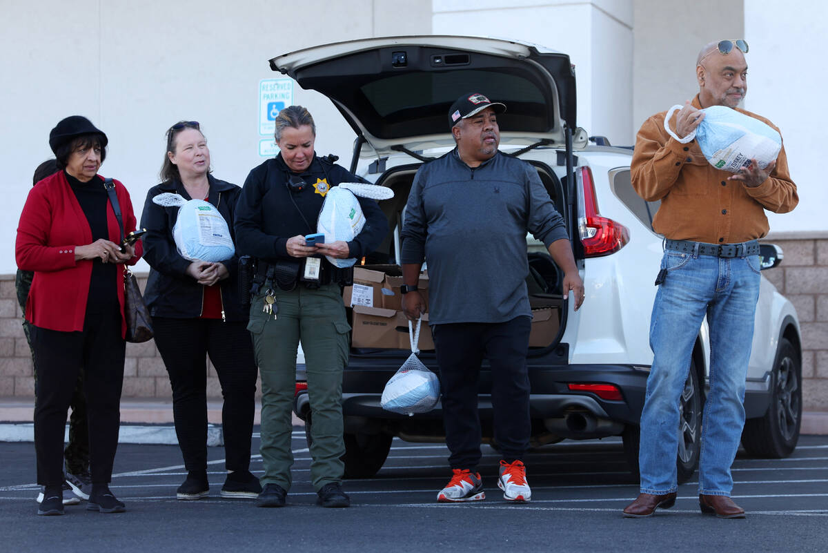 Rita Vaswani, from left, Faith Ramos, police officer Deborah Rinkovsky, Dennis Rucker, and Harr ...