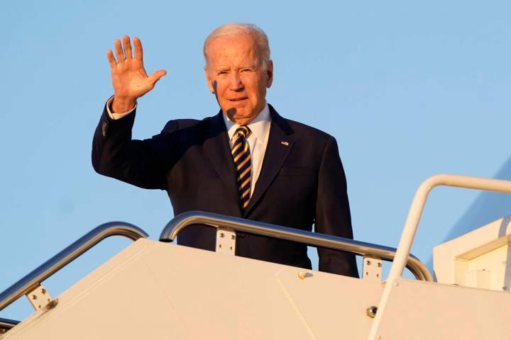 President Joe Biden waves as he boards Air Force One on Monday, Nov. 21, 2022, at Andrews Air F ...