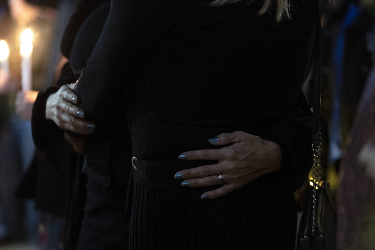 Mourners embrace during a vigil at the LGBTQ Center of Southern Nevada on Tuesday, Nov. 22, 202 ...