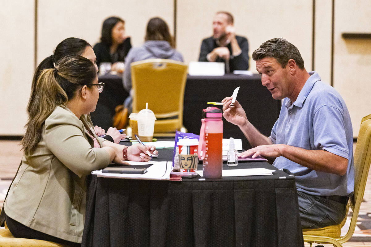 Jessica Santiago, left, beverage director at Treasure Island, listens to a job seeker during an ...