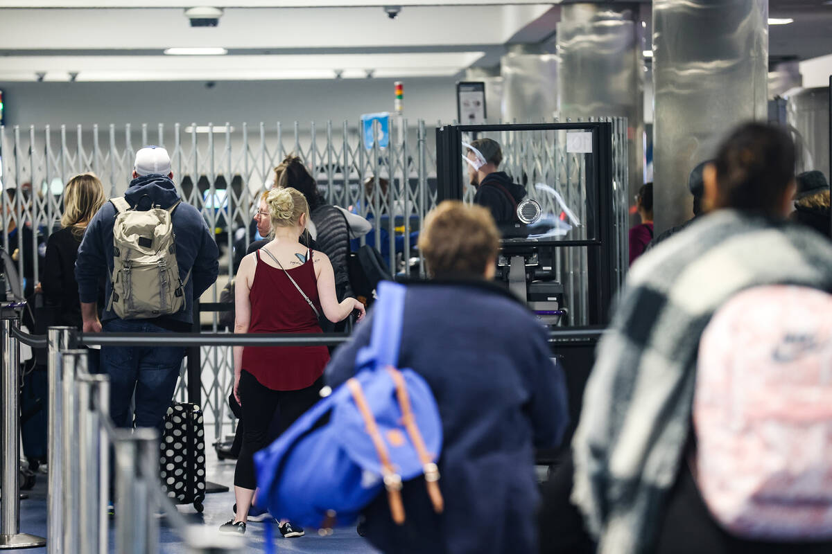 Travelers walk through security at Harry Reid International Airport in Las Vegas, Wednesday, No ...