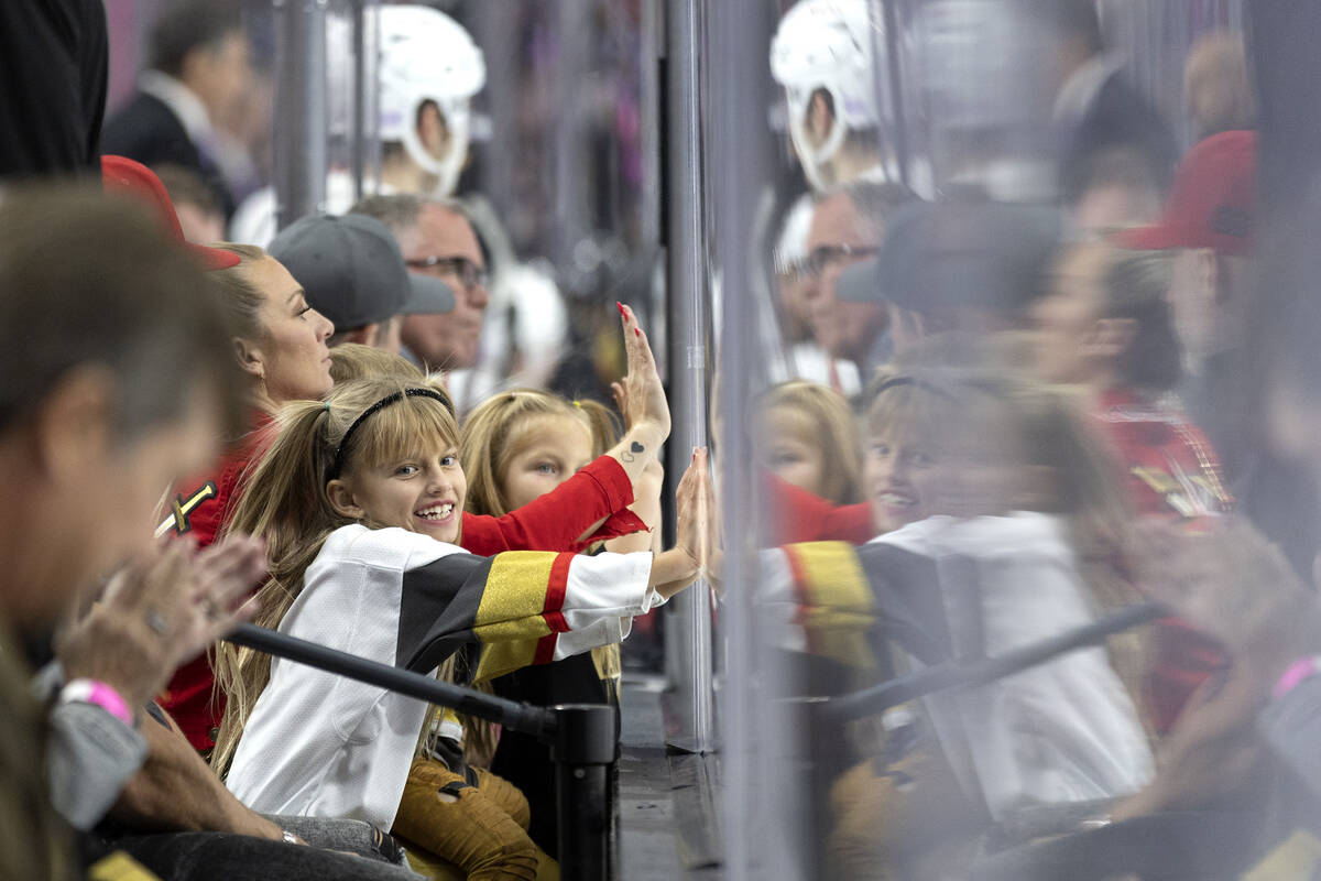 Young Golden Knights fans slam on the boards after left wing William Carrier (28) scored a goal ...