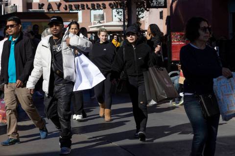 Shoppers carry their hauls during Black Friday sales at Las Vegas North Premium Outlets on Frid ...