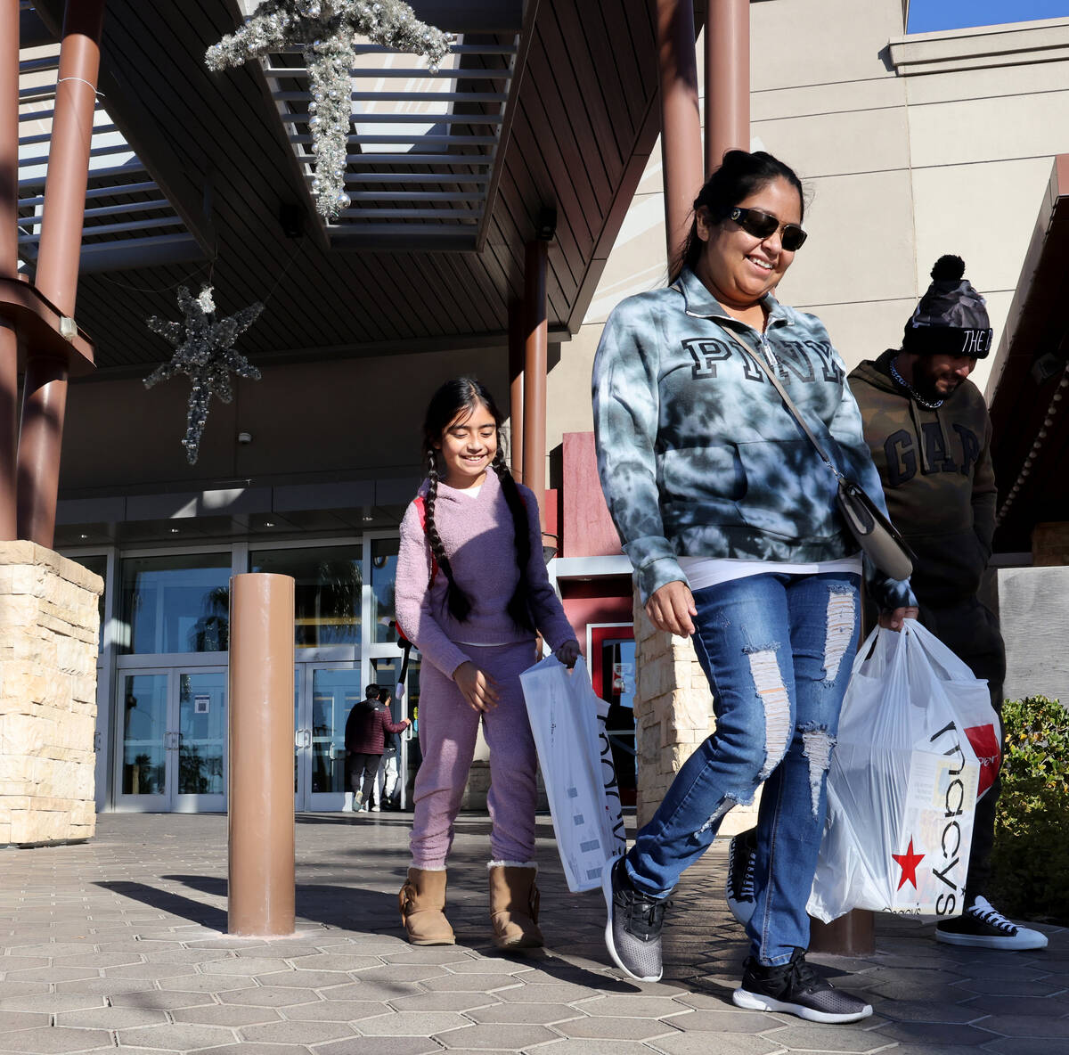 Grace Carrera, 11, from left, Jessica Rodriguez and Alfredo Carrera walk out of Galleria at Sun ...