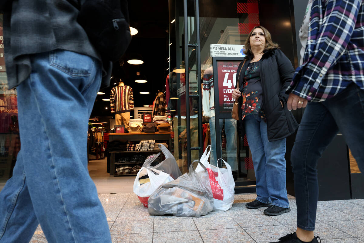 Martha Castro waits with her shopping bags at Galleria at Sunset mall in Henderson Friday, Nov. ...