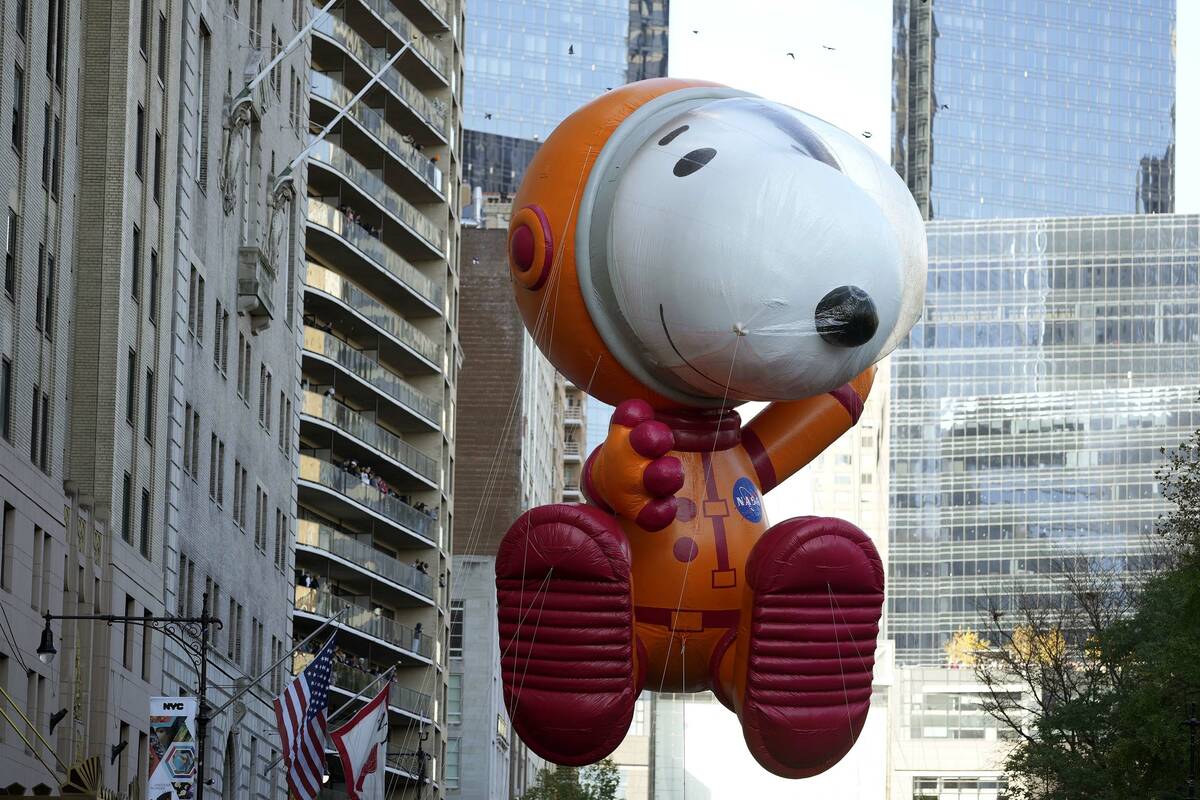 The Astronaut Snoopy balloon floats in the Macy's Thanksgiving Day Parade on Thursday, Nov. 24, ...