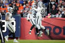 Las Vegas Raiders' Tyler Hall (37) is congratulated by linebacker Jayon Brown (50) and Maxx Cro ...