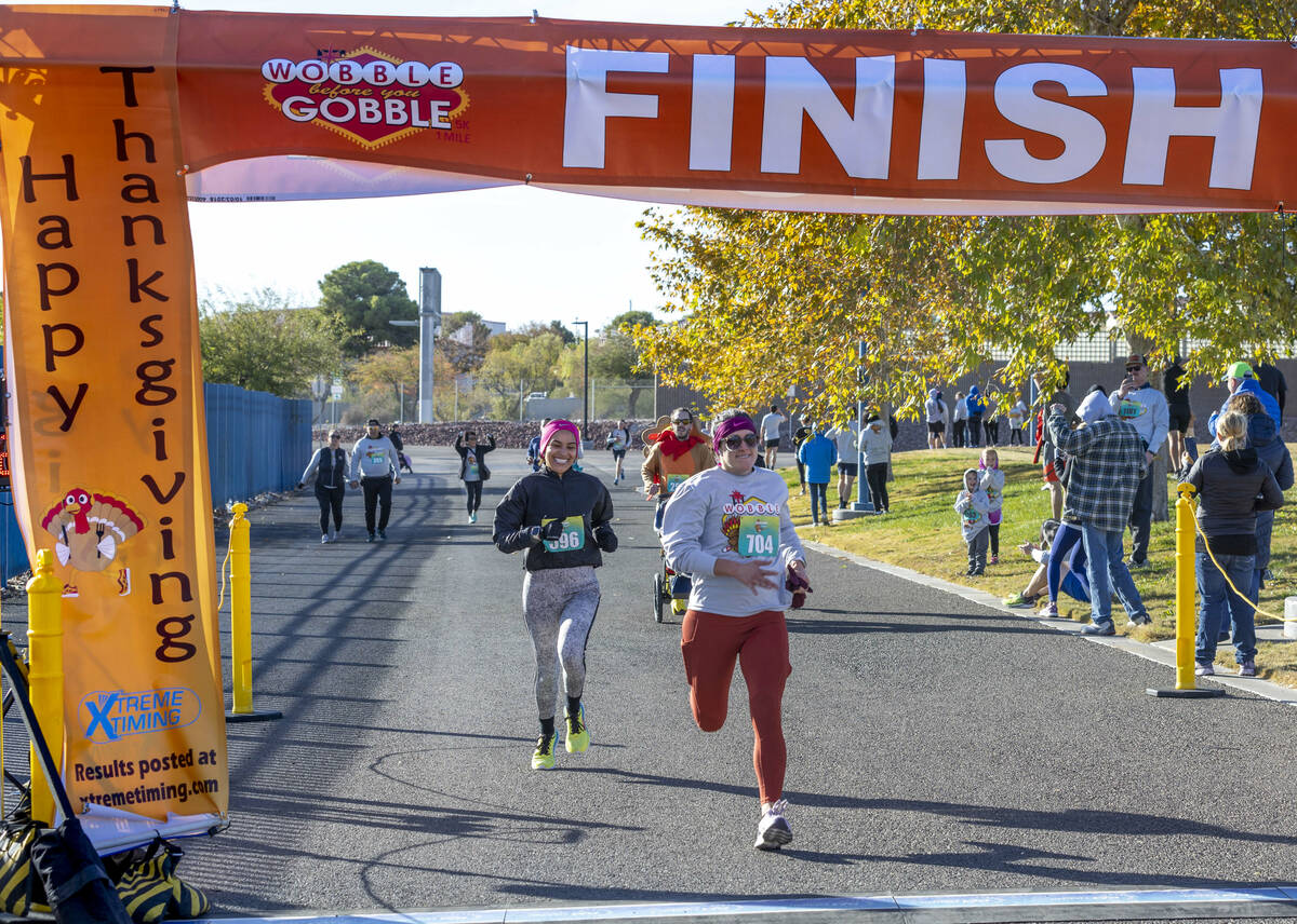 Participants streak to the finish line on the course during the Wobble Before You Gobble 5K run ...