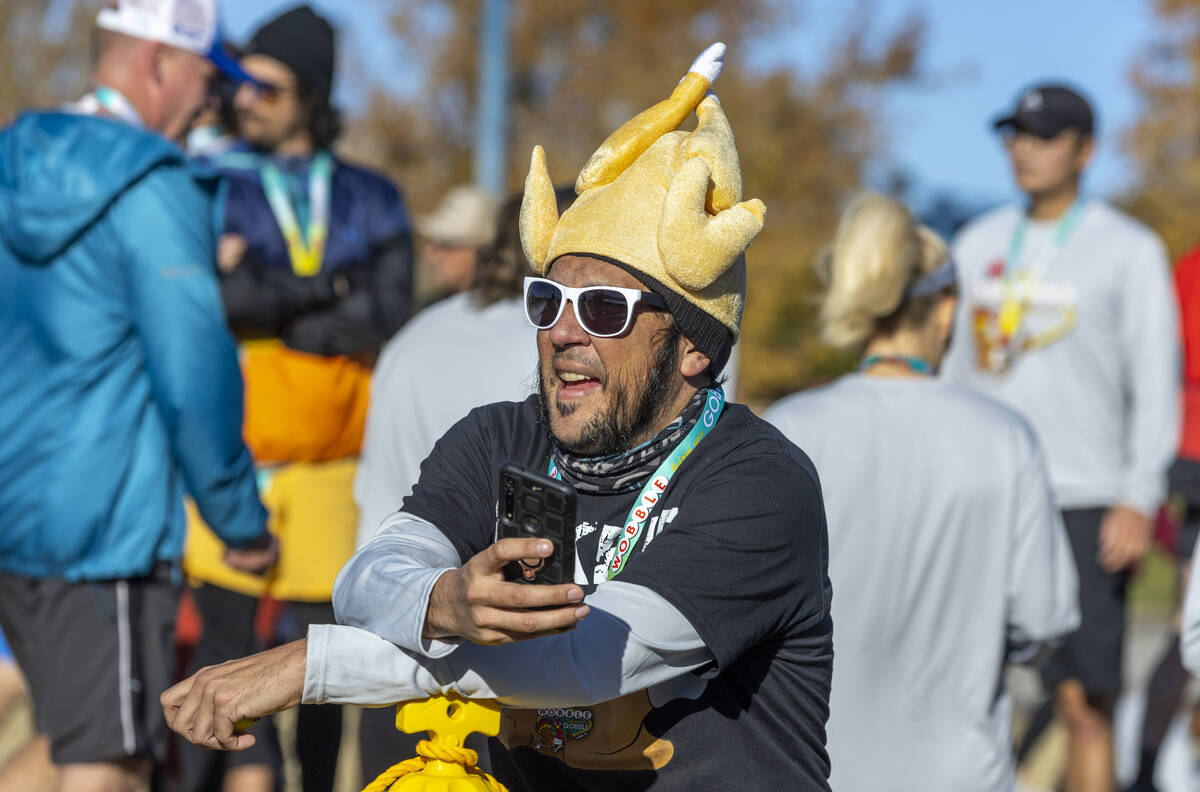 Participant Dominic Martinez cheers a friend's completion during the Wobble Before You Gobble 5 ...