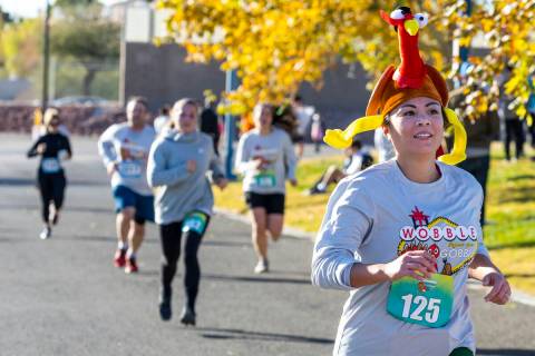 Participants cruise to the finish line on the course during the Wobble Before You Gobble 5K run ...