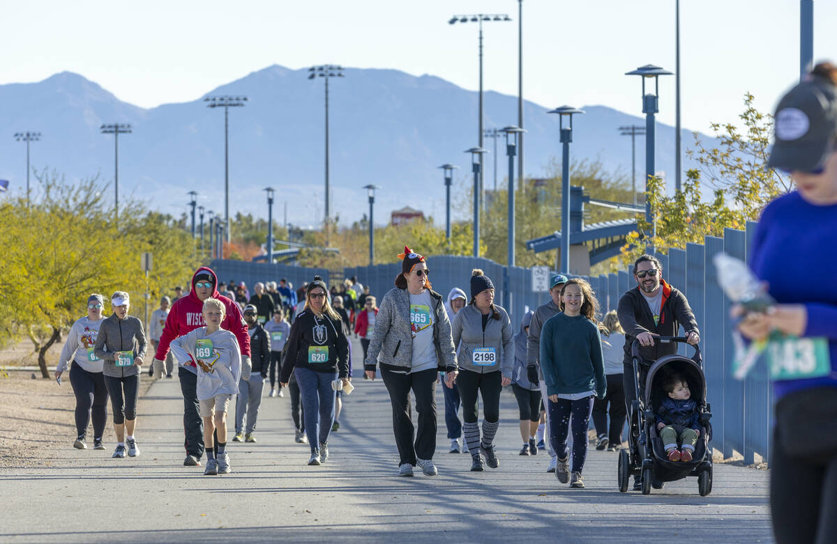 Participants make their way along the course during the Wobble Before You Gobble 5K run at Kell ...