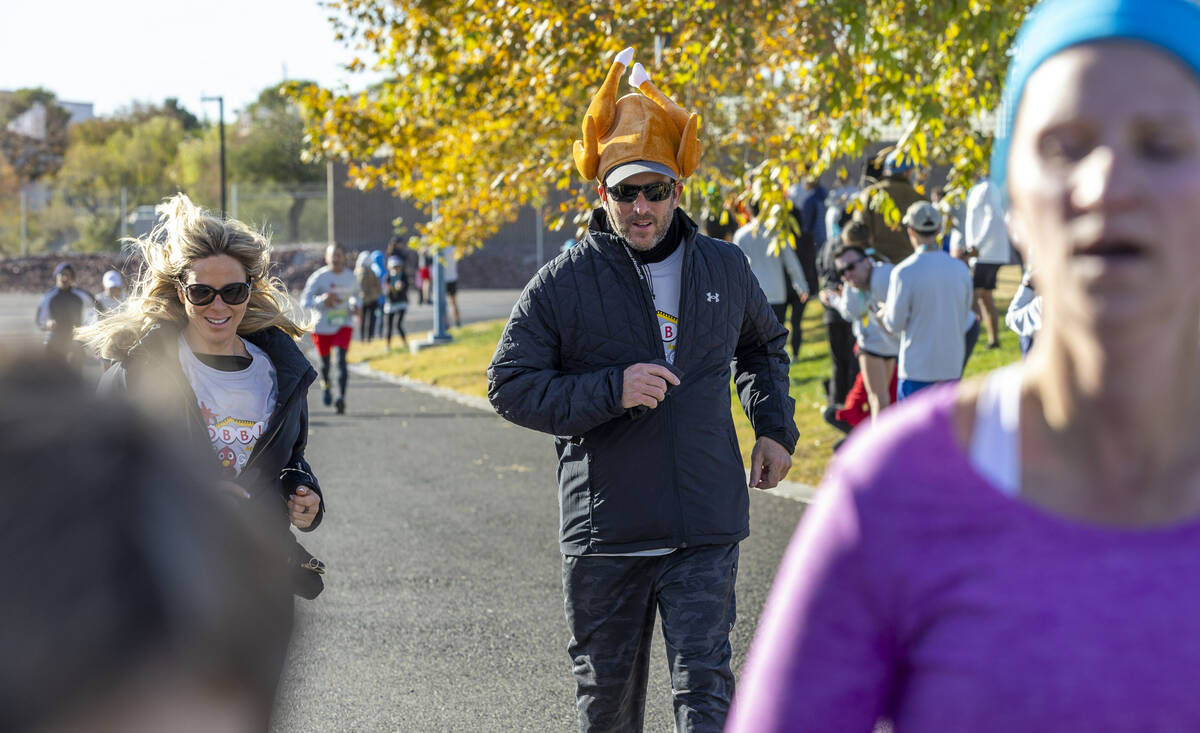 Participants cruise to the finish line on the course during the Wobble Before You Gobble 5K run ...