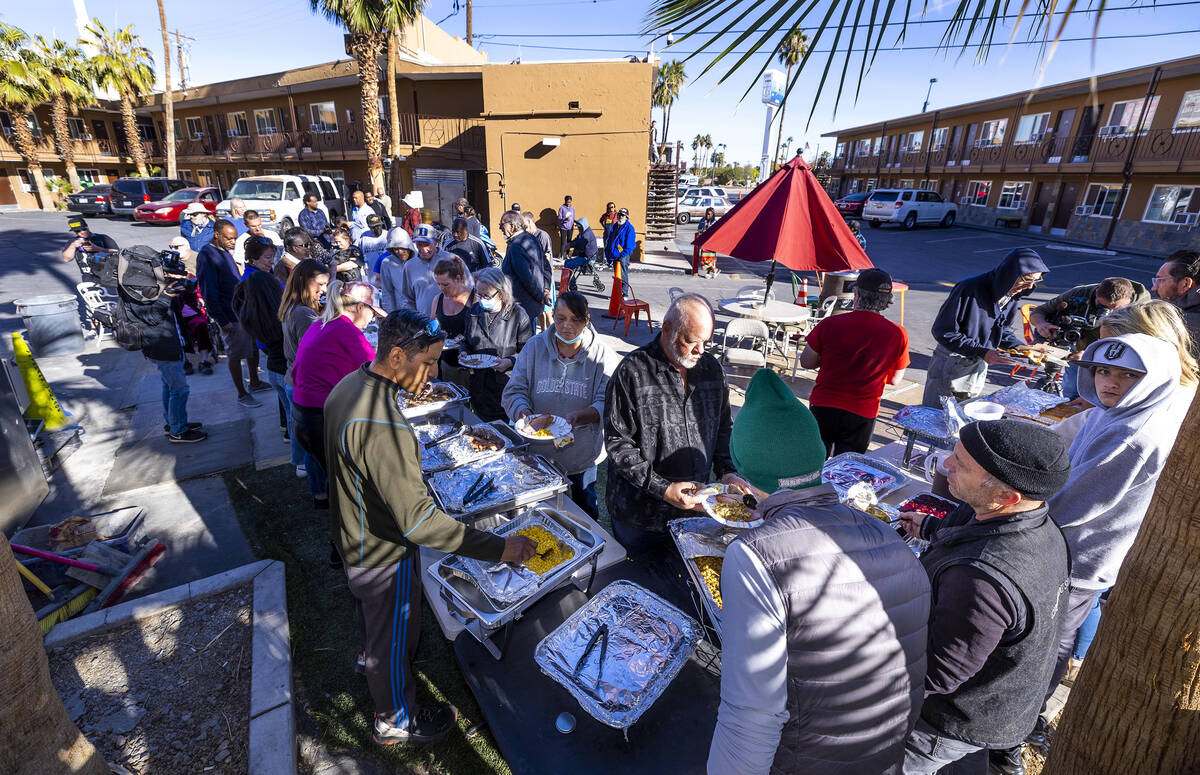 Hebron tenants are served a Thanksgiving meal there by community volunteers and Caridad Board m ...