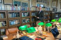 David Marler poses on Nov. 13, 2022, in his Rio Rancho, N.M., home library filled with books an ...