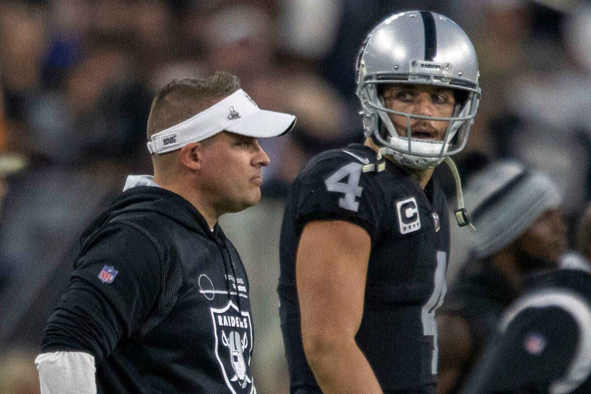 Raiders quarterback Derek Carr (4) looks to head coach Josh McDaniels at the end an NFL game wh ...