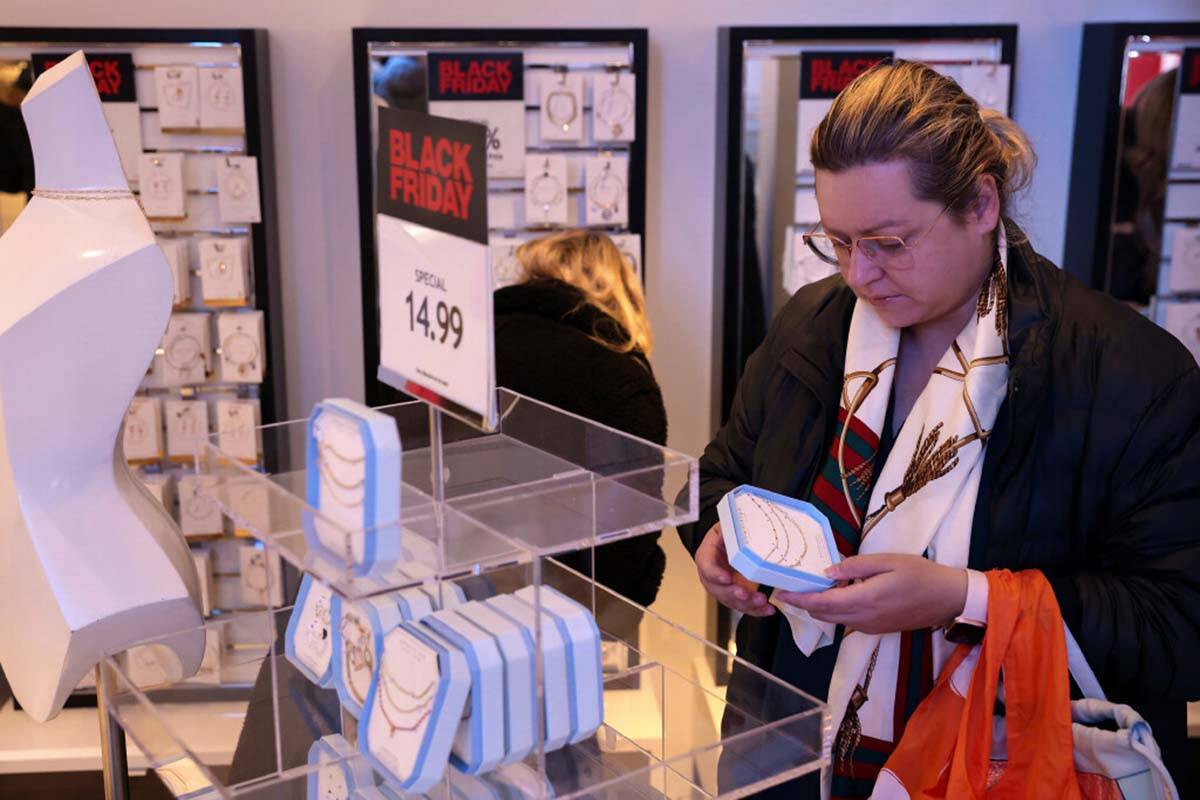Customers shop in a nearly-empty Macy's early on Black Friday, Nov. 25, 2022, in New York. (AP ...