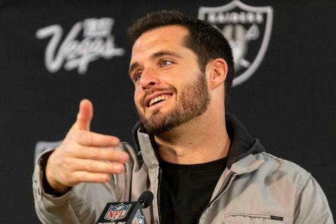 Raiders quarterback Derek Carr gestures during a news conference after taking a 22-16 win in ov ...
