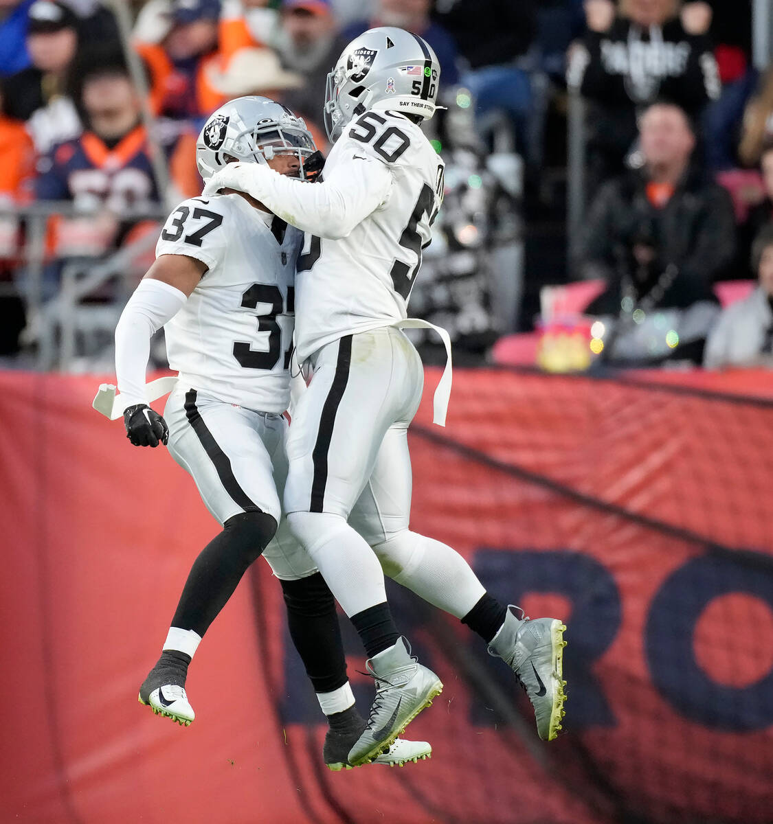 Las Vegas Raiders' Tyler Hall (37) is congratulated by linebacker Jayon Brown (50) and Maxx Cro ...