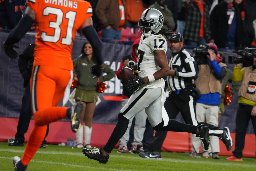 Las Vegas Raiders wide receiver Davante Adams (17) scores the game winning touchdown in overtim ...