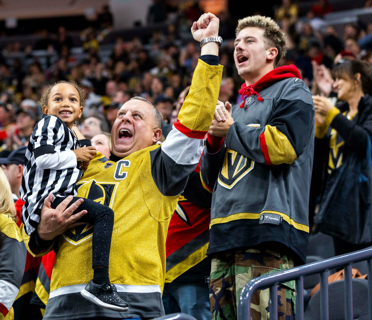 Golden Knights fans celebrate a score over the Seattle Kraken during the first period of their ...