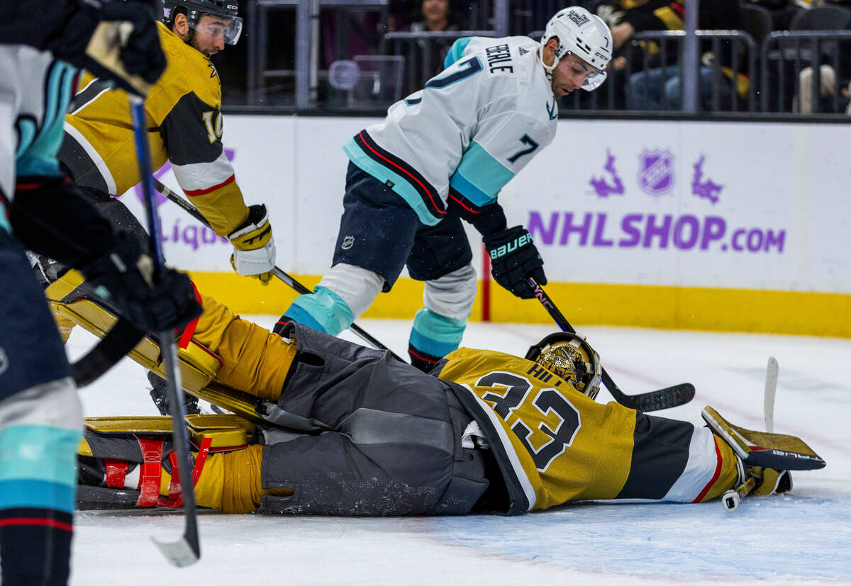 Golden Knights goaltender Adin Hill (33) dives but its late as the puck goes into the net from ...