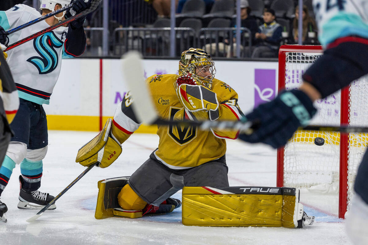 Golden Knights goaltender Adin Hill (33) looks as the puck goes into the net from Seattle Krake ...