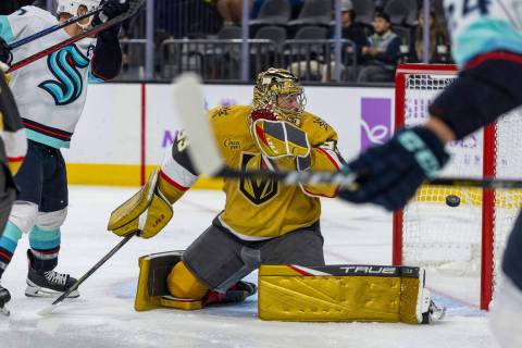 Golden Knights goaltender Adin Hill (33) looks as the puck goes into the net from Seattle Krake ...