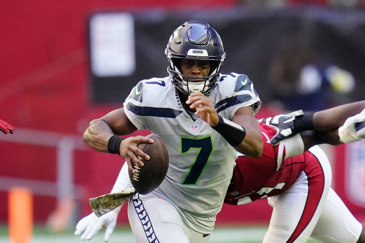 Seattle Seahawks quarterback Geno Smith runs with the ball against the Arizona Cardinals during ...