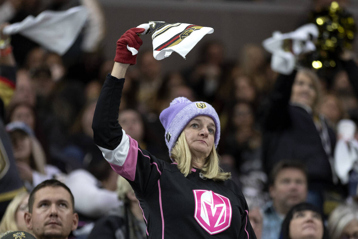 A Golden Knights fan unenthusiastically waves her game towel during the second period of an NHL ...