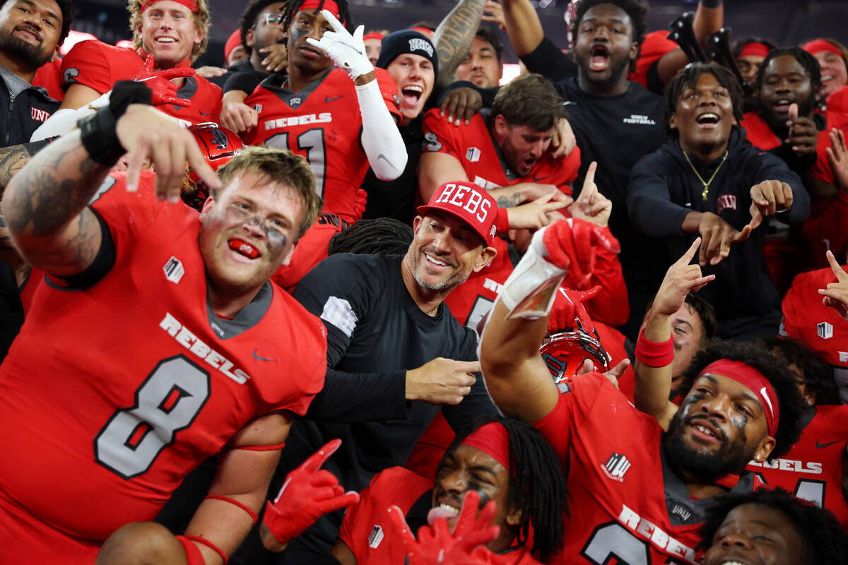 The UNLV Rebels poses for photos with the Fremont Cannon after their team's win against the Nev ...