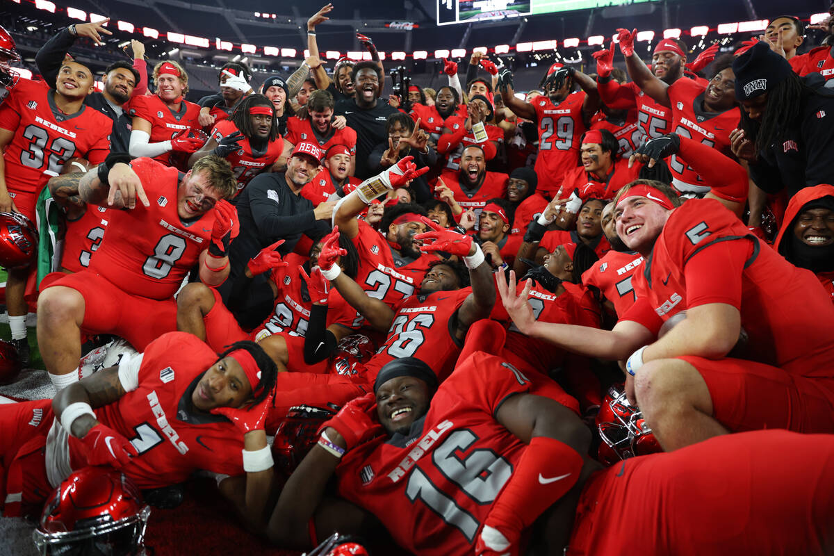The UNLV Rebels poses for photos with the Fremont Cannon after their team's win against the Nev ...