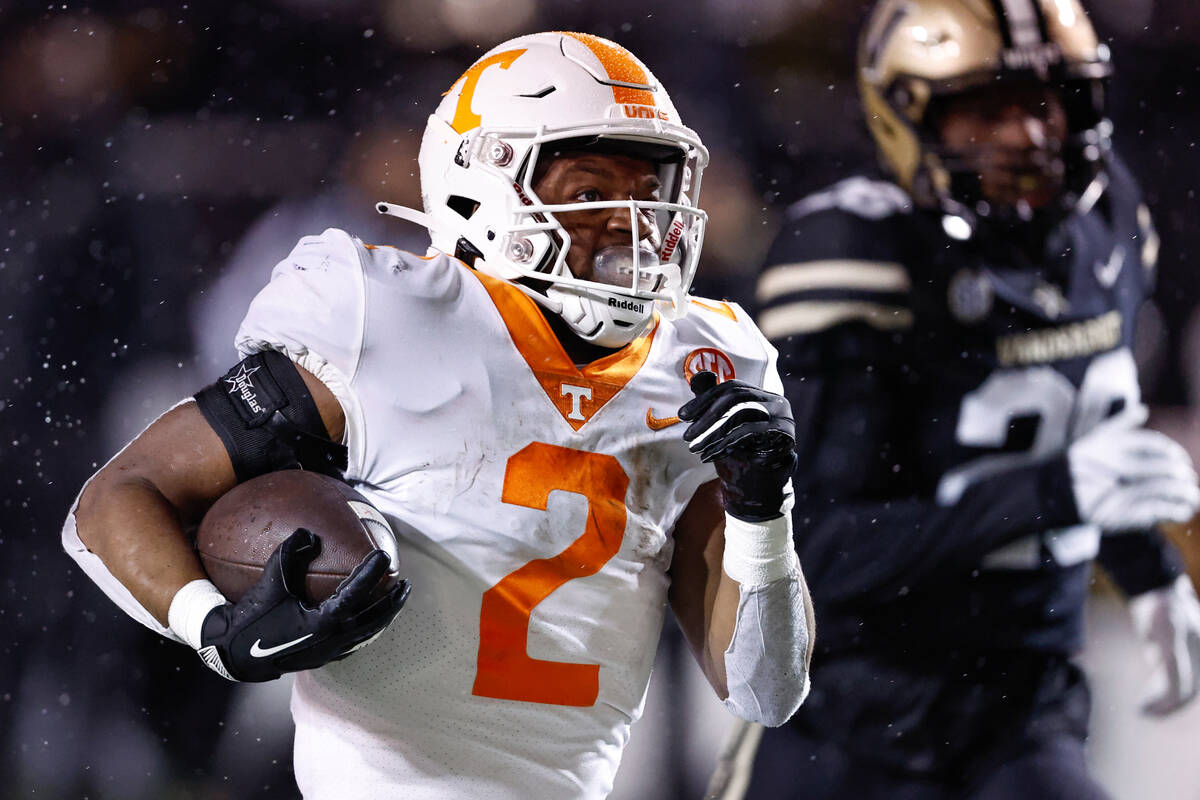 Tennessee running back Jabari Small (2) runs for a touchdown as he's chased by Vanderbilt corne ...