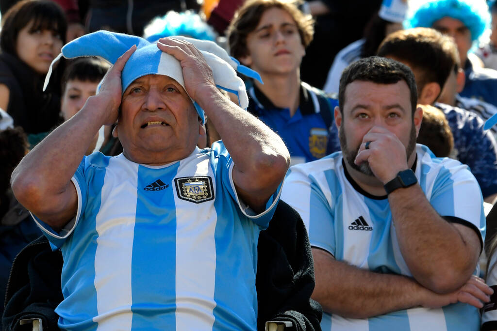 FILE - Argentina soccer fans watch the team lose to Saudi Arabia at a World Cup Group C soccer ...