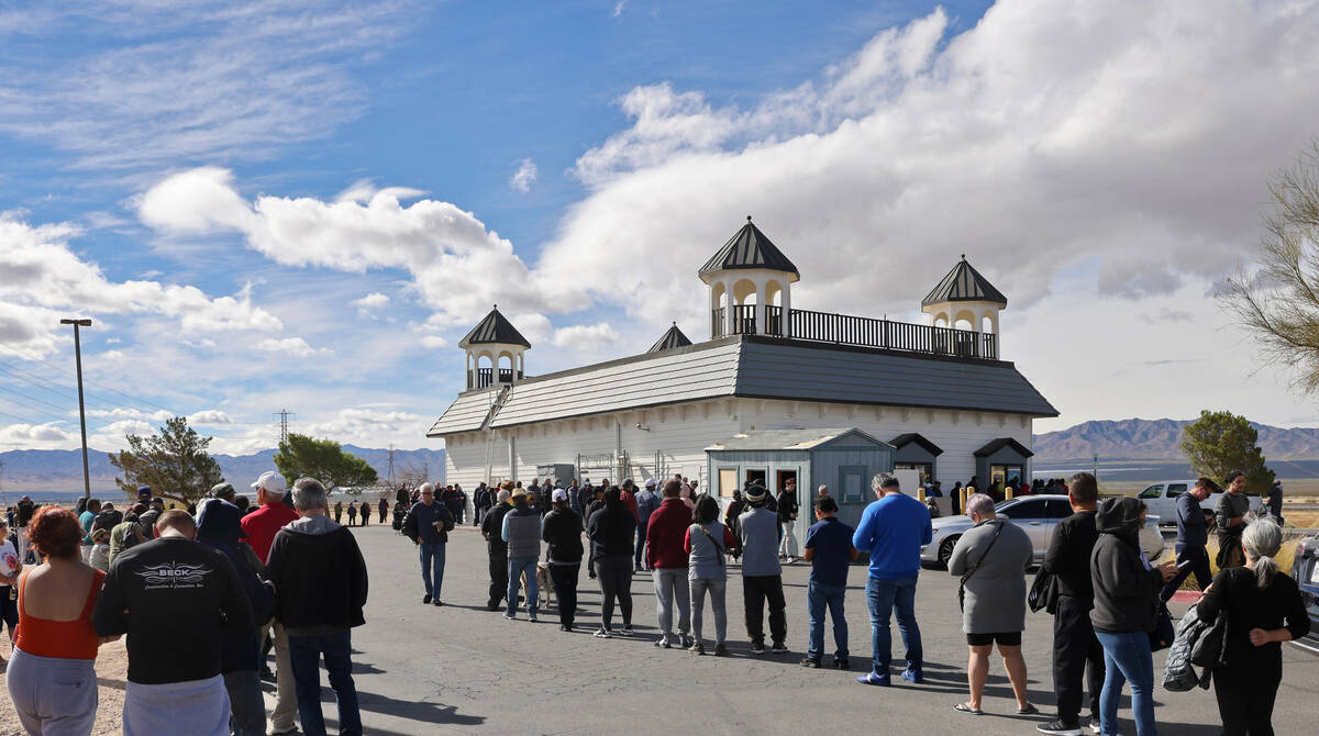 People wait in line to buy lottery tickets at the Lotto Store just across the Nevada/California ...