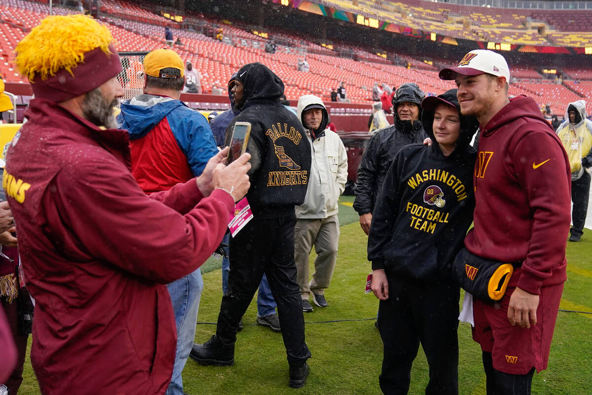 Washington Commanders quarterback Taylor Heinicke (4) poses for photos with fans before the sta ...