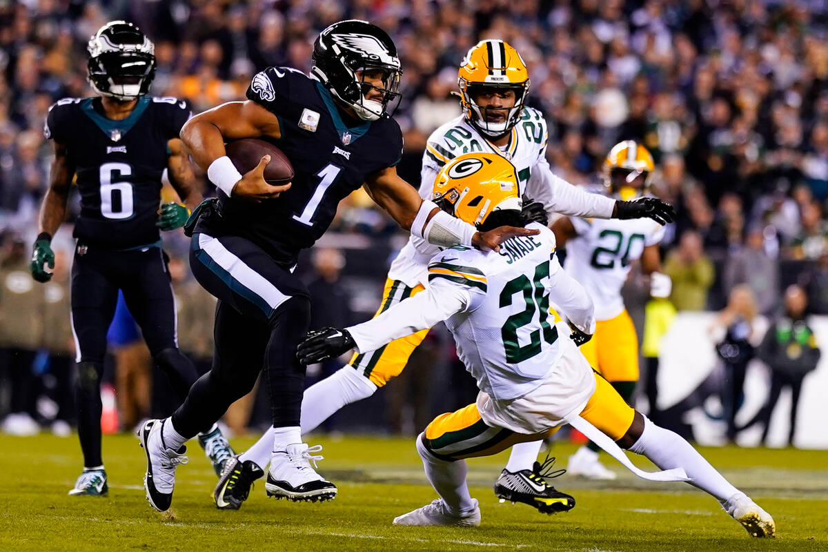 Philadelphia Eagles quarterback Jalen Hurts (1) runs past Green Bay Packers safety Darnell Sava ...