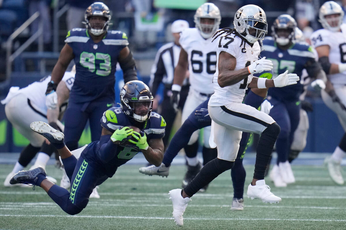 Seattle Seahawks safety Quandre Diggs, left, intercepts a pass intended for Las Vegas Raiders w ...