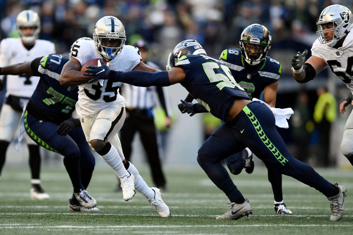Las Vegas Raiders running back Zamir White carries against the Seattle Seahawks during the seco ...