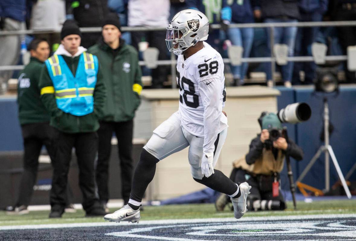 Raiders running back Josh Jacobs (28) scores a touchdown during the first half of an NFL game a ...