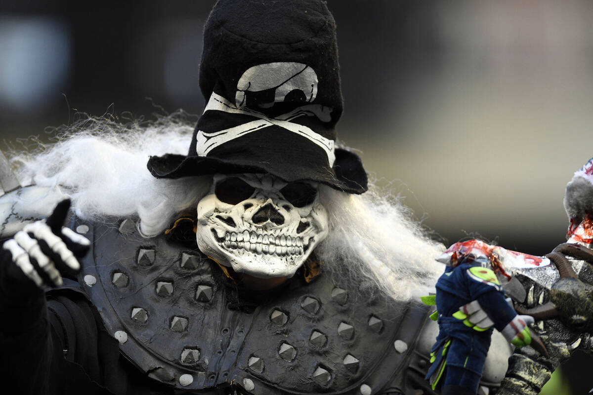 A Las Vegas Raiders fan cheers during the second half of an NFL football game against the Seatt ...