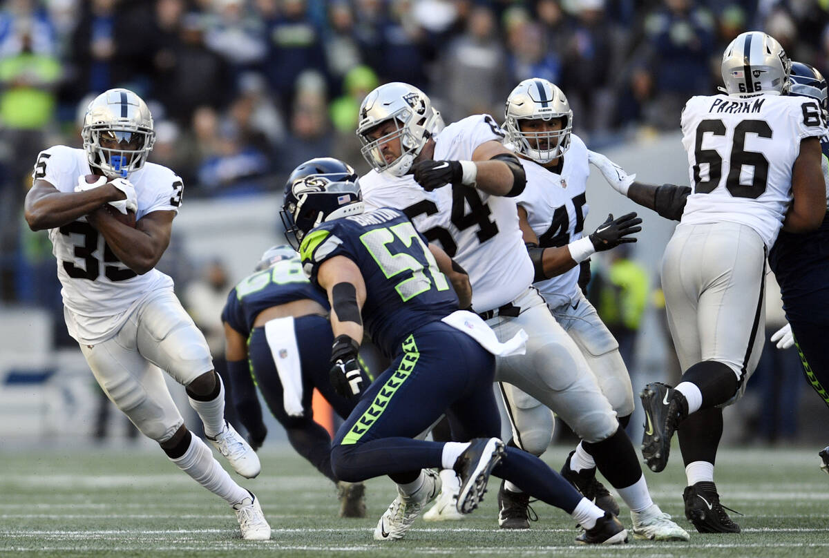 Las Vegas Raiders running back Zamir White (35) carries against the Seattle Seahawks during the ...