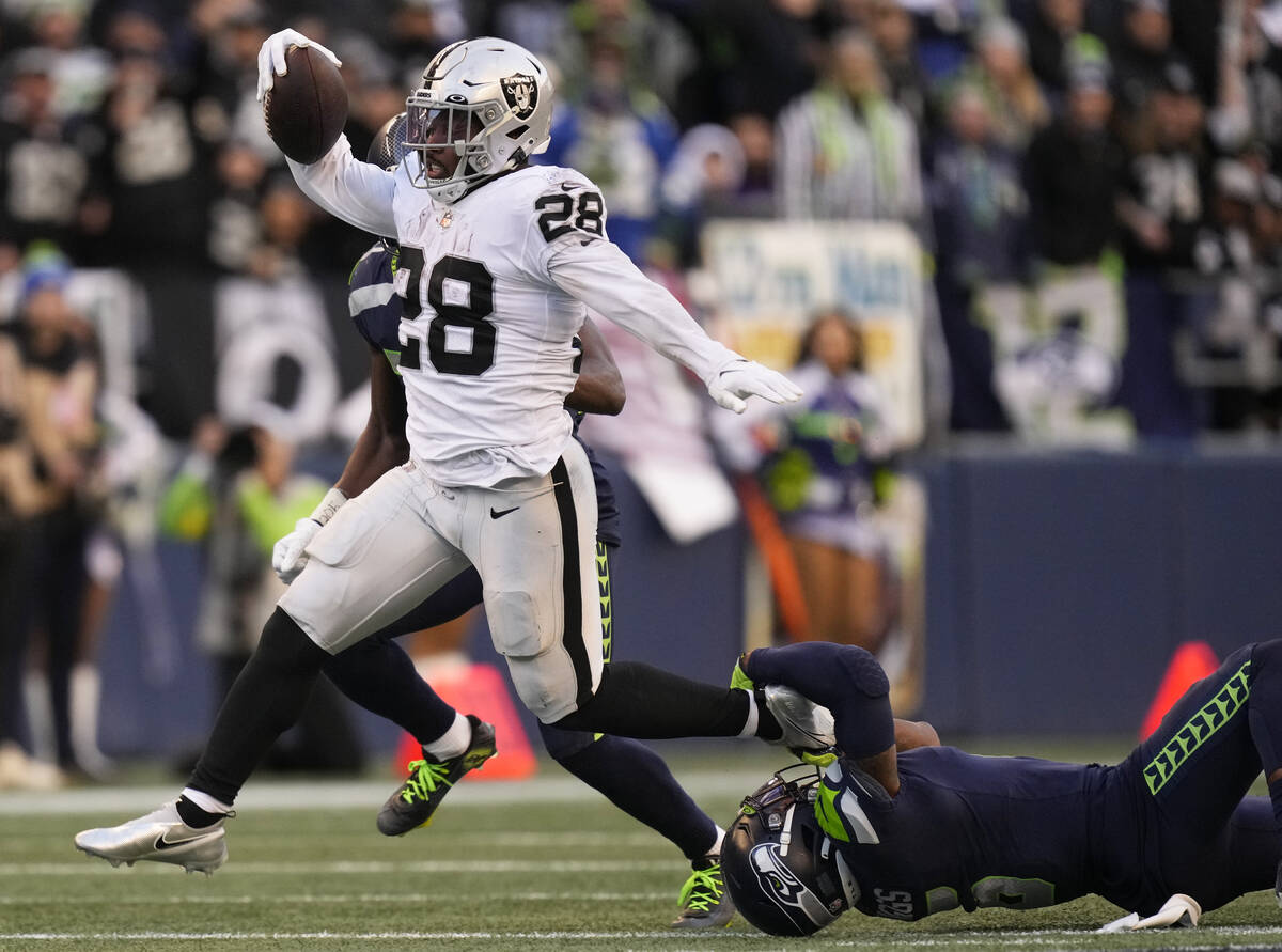 Las Vegas Raiders running back Josh Jacobs (28) runs with the ball during an NFL football game ...