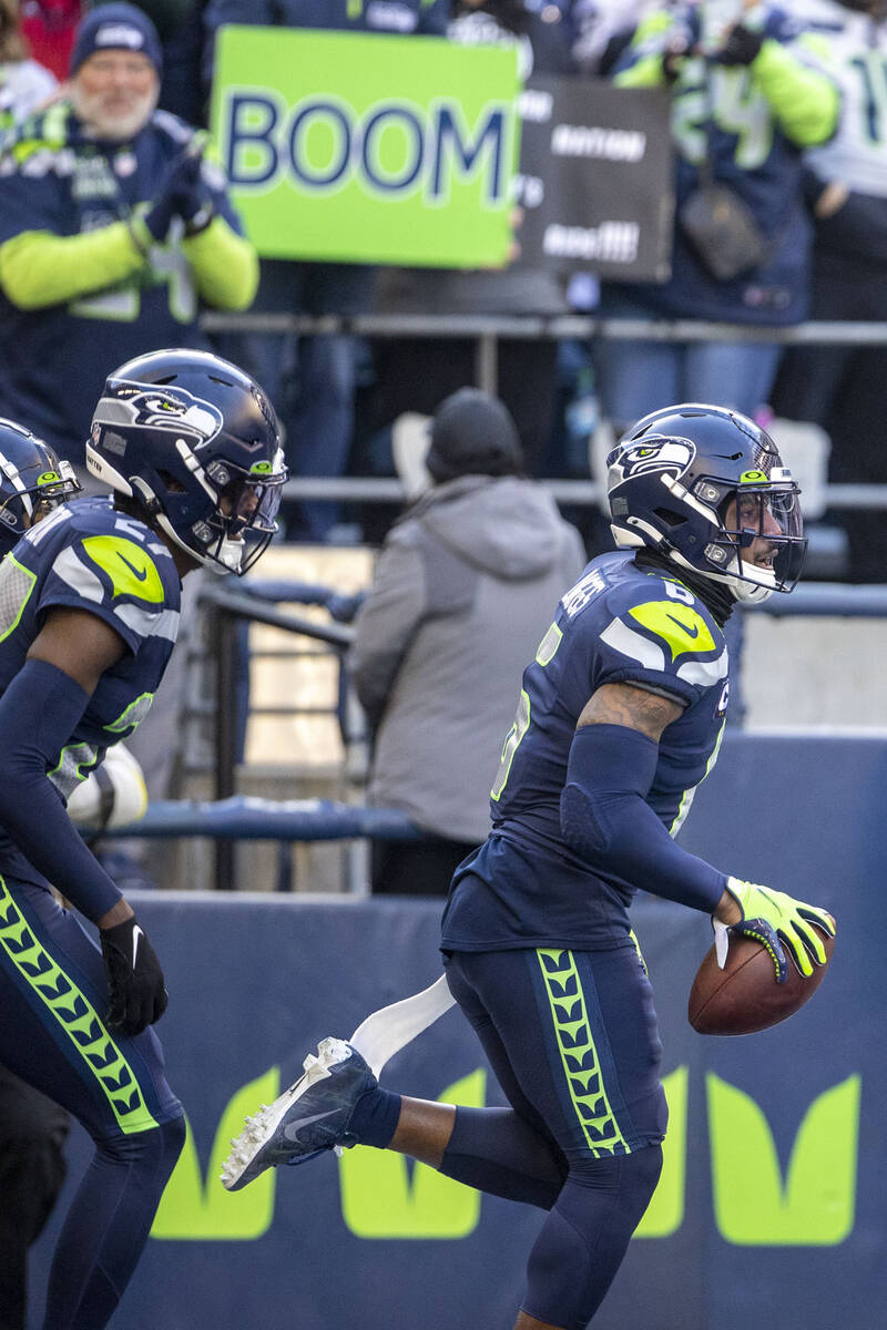 Seattle Seahawks safety Quandre Diggs (6) runs back an interception during the first half of an ...