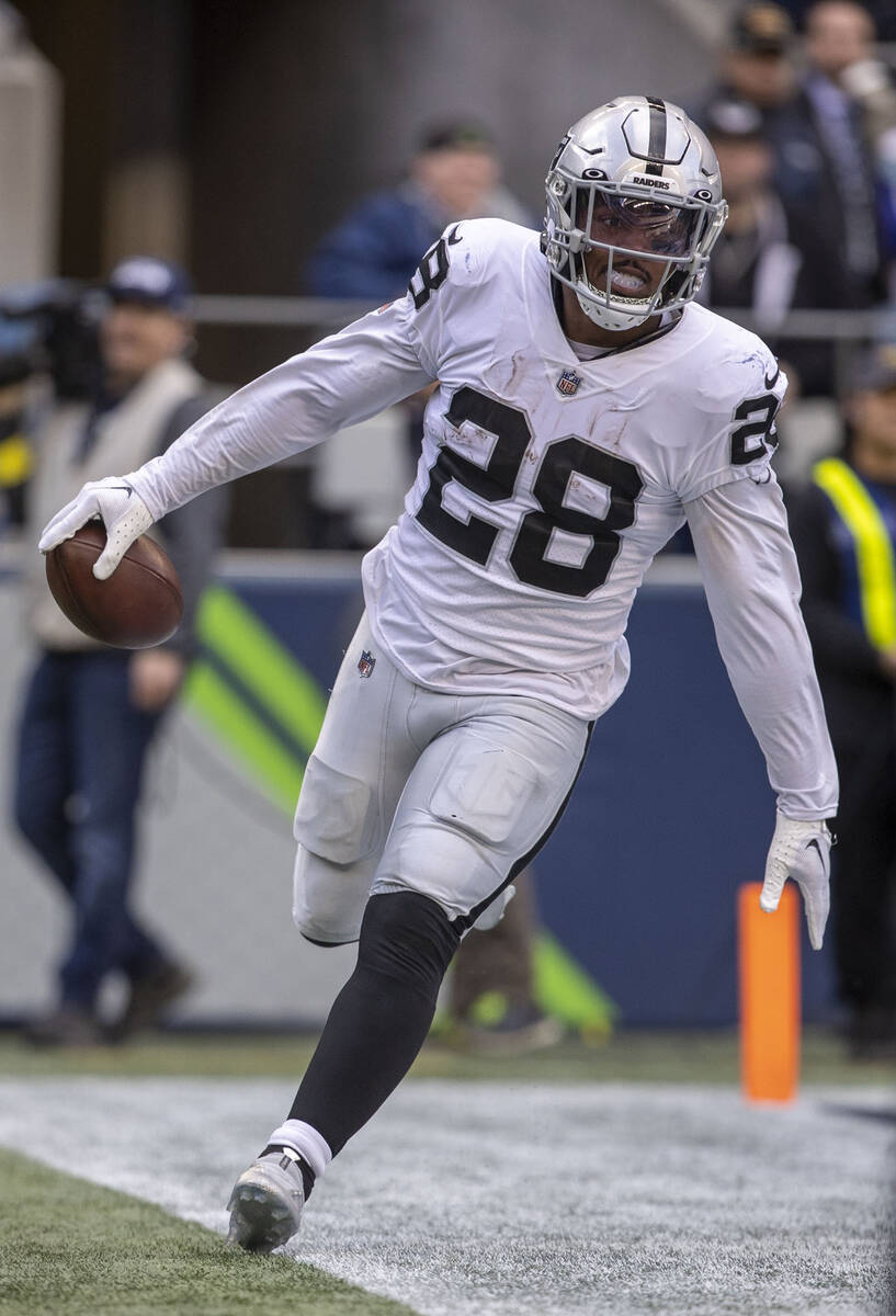 Raiders running back Josh Jacobs (28) scores a touchdown during the first half of an NFL game a ...