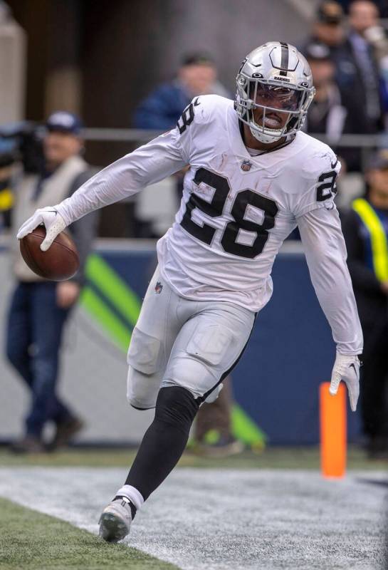 Raiders running back Josh Jacobs (28) scores a touchdown during the first half of an NFL game a ...