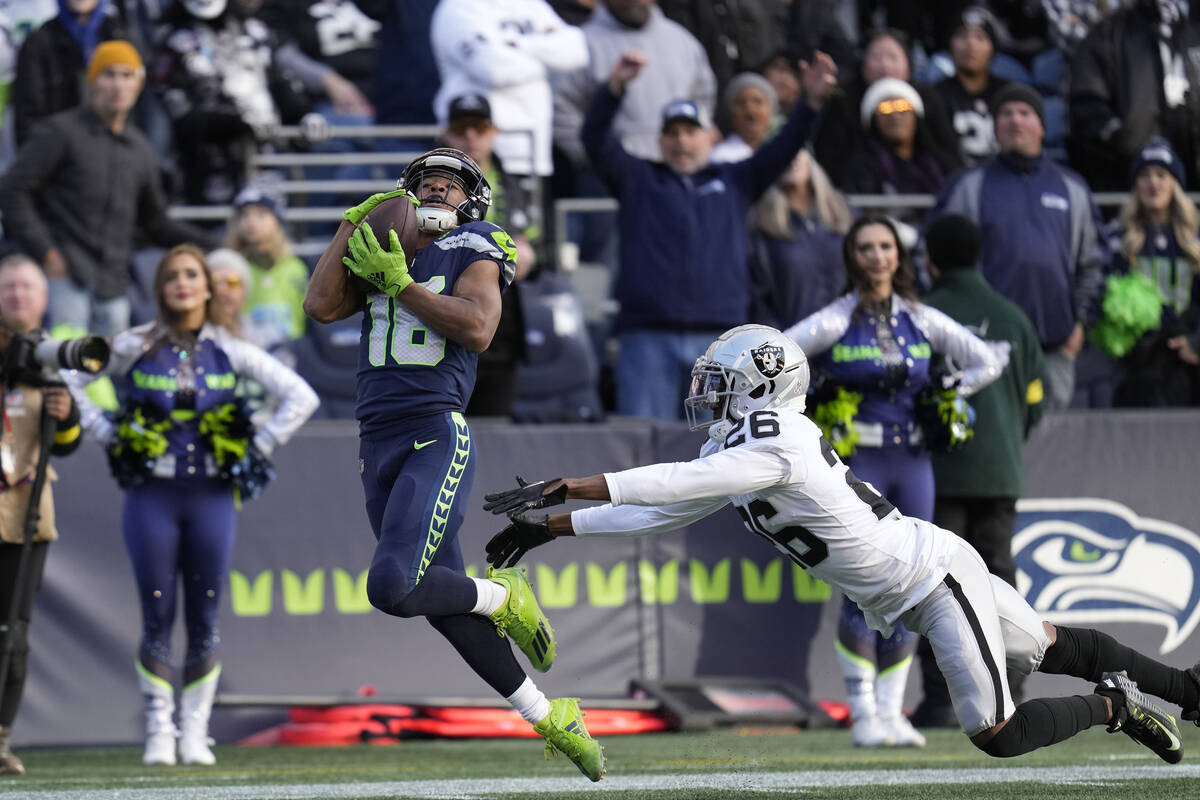 Seattle Seahawks wide receiver Tyler Lockett catches a touchdown past Las Vegas Raiders cornerb ...