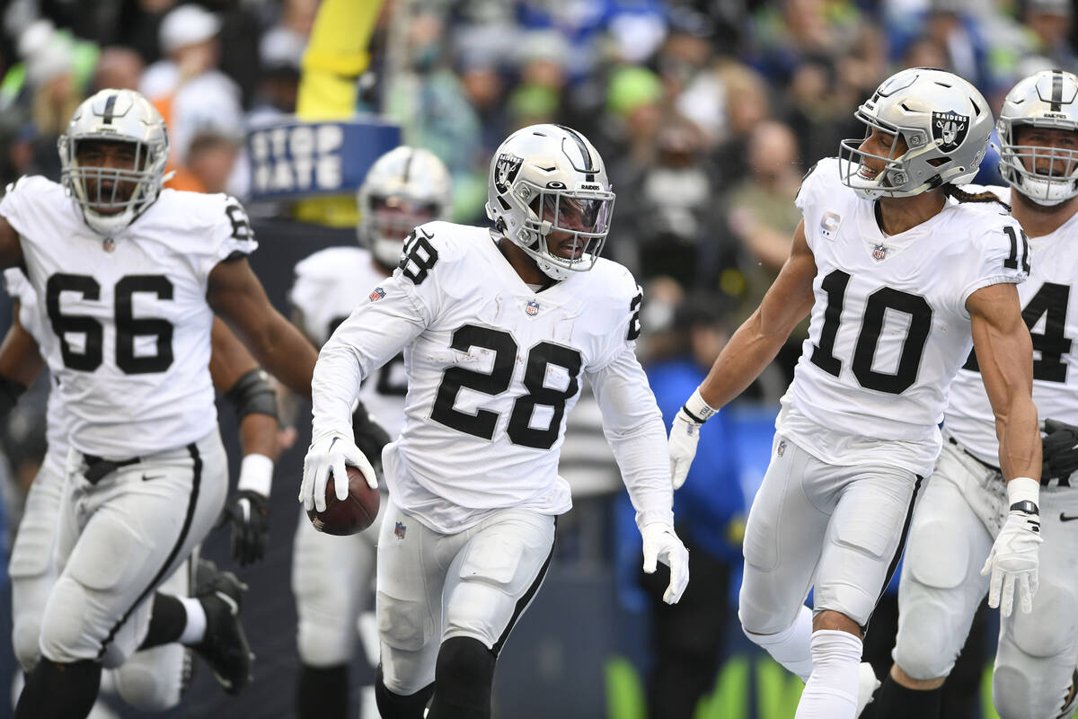 Las Vegas Raiders running back Josh Jacobs (28) celebrates after scoring a touchdown during the ...